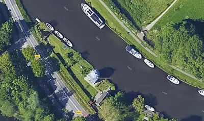 an overhead view of boats parked in a river at Historical house on river Vecht in Maarssen