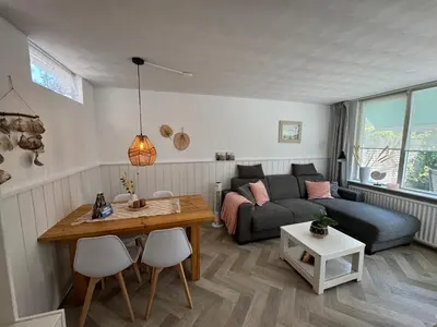 a living room with a couch and a table at Strandduin - Vakantiewoning aan de Kust - 52 in Egmond aan Zee