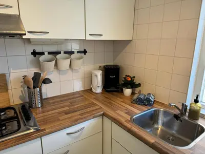 a kitchen with a sink and a counter top at Strandduin - Vakantiewoning aan de Kust - 52 in Egmond aan Zee
