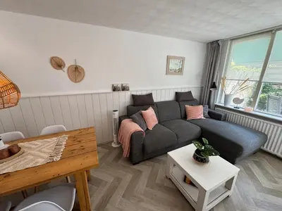 a living room with a couch and a table at Strandduin - Vakantiewoning aan de Kust - 52 in Egmond aan Zee