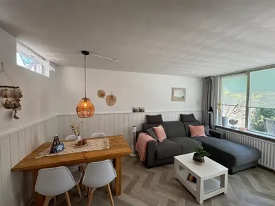 a living room with a couch and a table at Strandduin - Vakantiewoning aan de Kust - 52 in Egmond aan Zee