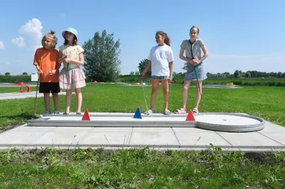a group of children standing on a trampoline at Camping de Speld in Nieuwkoop