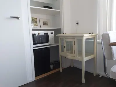 a small table in a room with a microwave at Sky Home Room 1 in Amsterdam