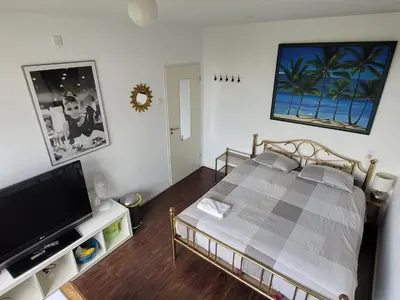 a bedroom with a bed and a flat screen tv at Sky Home Room 1 in Amsterdam