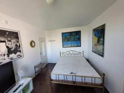 a bedroom with a bed and a flat screen tv at Sky Home Room 1 in Amsterdam