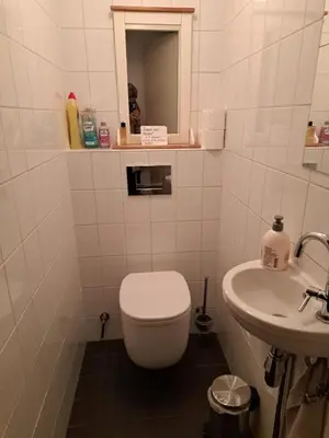 a bathroom with a toilet and a sink at Sky Home Room 1 in Amsterdam