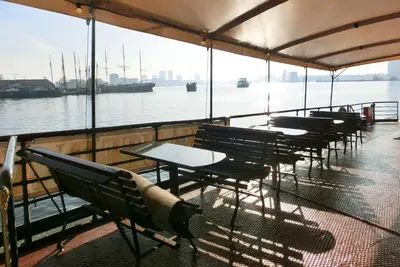 a row of tables and chairs on a boat at Kapitein Anna in Amsterdam