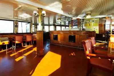a dining room with a bar and tables and chairs at Kapitein Anna in Amsterdam