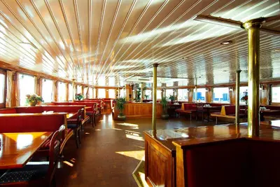 a dining room with wooden tables and chairs at Kapitein Anna in Amsterdam