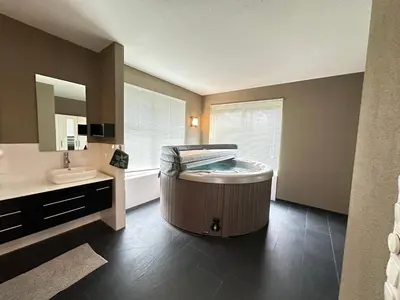 a bathroom with a large tub in the middle of the room at Groot vakantiehuis nabij Amsterdam inclusief jacuzzi in Zeewolde