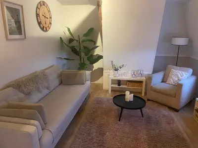 a living room with a couch and a chair and a table at Veldhorst Apartments in Leiden
