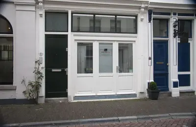 a white door on a building with a blue door at B&B Chez Cho in Utrecht