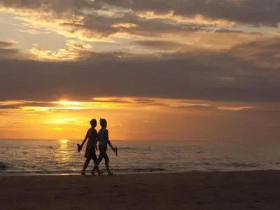 a couple walking on the beach at sunset at Chalet in Noordwijk near the Beach in Noordwijk aan Zee
