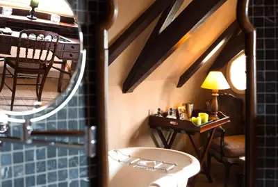 a bathroom with a sink and a mirror at Suitehotel Posthoorn in Monnickendam