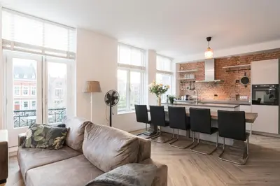 a living room with a couch and a kitchen at Canal House Haarlem in Haarlem