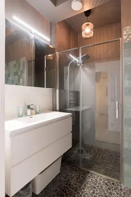 a bathroom with a white sink and a shower at Canal House Haarlem in Haarlem