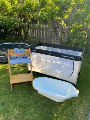 a bed and a chair sitting in the grass at Huis Egmond in Egmond aan den Hoef