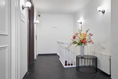 a hallway with a vase of flowers on a table at Nova Apartments Amsterdam in Amsterdam
