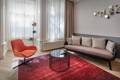 a living room with a couch and a chair at Nova Apartments Amsterdam in Amsterdam