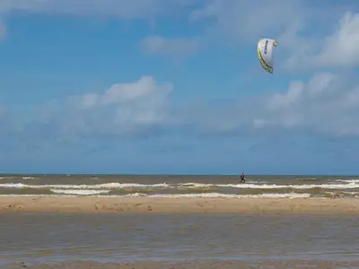 a person is flying a kite on the beach at Holiday Home in Noordwijk near the Beach in Noordwijk aan Zee