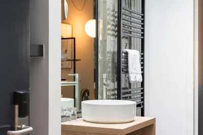 a bathroom with a sink and a mirror at Badhuis Hotel in Utrecht