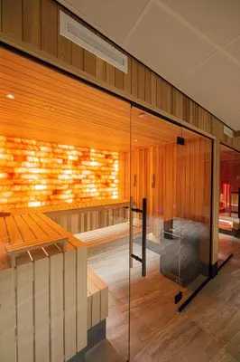 a room with a sauna with a glass wall at Strandhotel Het Hoge Duin in Wijk aan Zee