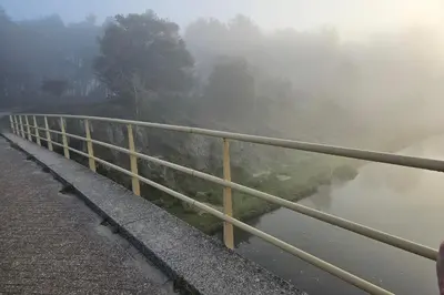 a fence next to a river in the fog at De Schelp 58 in Zandvoort