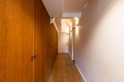 a hallway with wooden walls and a white wall at Townhouse 't Raap in Amsterdam