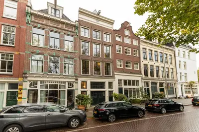 two cars parked in front of a brick building at Townhouse 't Raap in Amsterdam