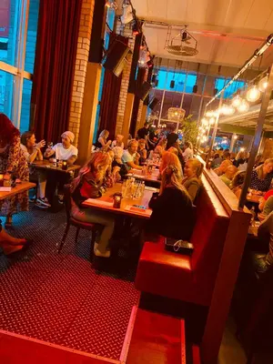 a group of people sitting at tables in a restaurant at Anno in Almere