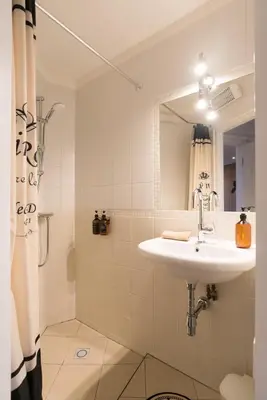 a bathroom with a sink and a shower at Canal view home in the center in Amsterdam