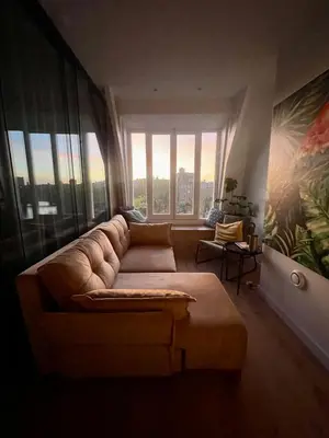 a living room with a couch and a large window at Canal view home in the center in Amsterdam