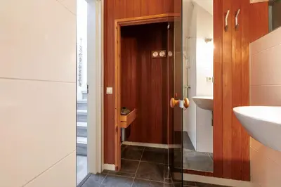 a bathroom with a toilet and a sink at Dormio Park Scorleduyn in Schoorl