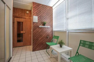 a room with two chairs and a table and a door at Fletcher Hotel Restaurant Zeeduin in Wijk aan Zee