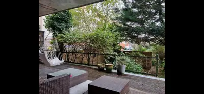 a patio with chairs and a table and a fence at Quiet Garden Room Amsterdam West - by Peter in Amsterdam