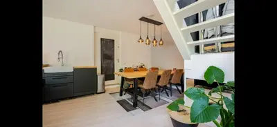 a kitchen and dining room with a table and a sink at Quiet Garden Room Amsterdam West - by Peter in Amsterdam