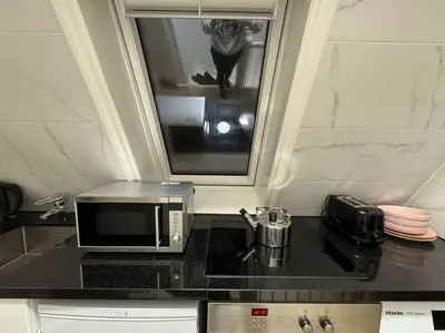 a kitchen counter with a microwave and a toaster at Best Neighbourhood Apartment in Amsterdam