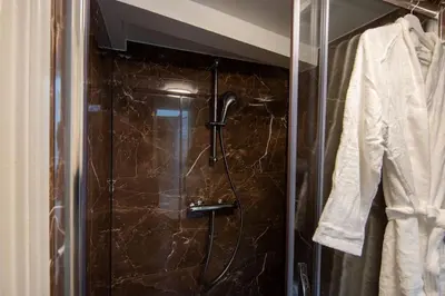a shower with a glass door in a bathroom at Best Neighbourhood Apartment in Amsterdam