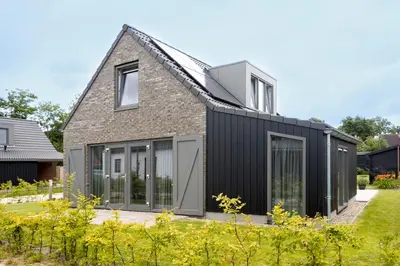 an extension to a house with black siding at De Strandwielen in Sint Maarten