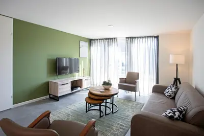 a living room with a couch and a tv at De Strandwielen in Sint Maarten