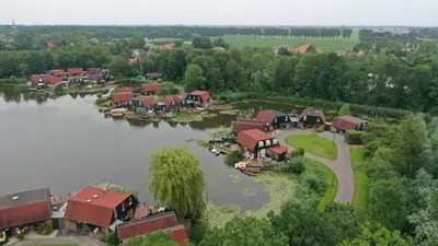 an aerial view of a village on a lake at Lakeside Cottage De Rijd in Nieuwe-Niedorp