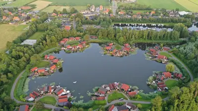 an aerial view of a village with a lake at Lakeside Cottage De Rijd in Nieuwe-Niedorp