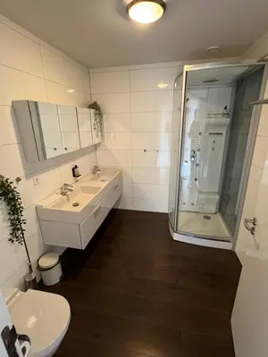 a bathroom with a shower and a sink and a toilet at Cala Bassa Beach Boutique Apartments - Sea View in Overveen