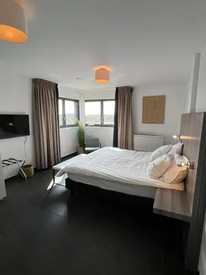 a bedroom with a large bed in a room at Cala Bassa Beach Boutique Apartments - Beach View in Overveen