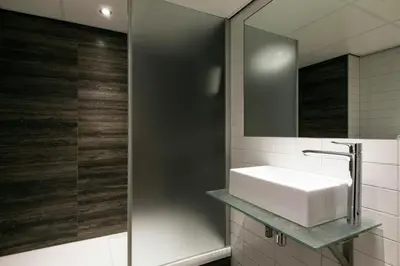 a bathroom with a sink and a mirror at NYX Hotel Amsterdam Rembrandt Square in Amsterdam