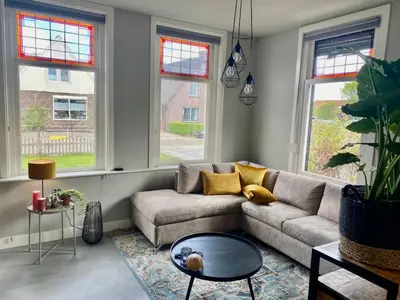 a living room with a couch and a table at welkom bij 5 in Den Ilp