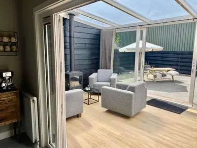 a living room with two chairs and a fireplace at welkom bij 5 in Den Ilp