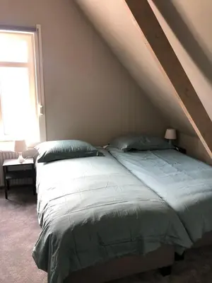 a bedroom with a large bed with a roof at welkom bij 5 in Den Ilp