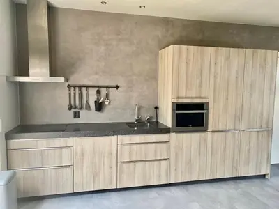 a kitchen with wooden cabinets and a counter top at welkom bij 5 in Den Ilp