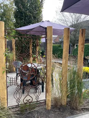 a table and chair with an umbrella on a patio at Holiday in Spakenburg Groof in Spakenburg
